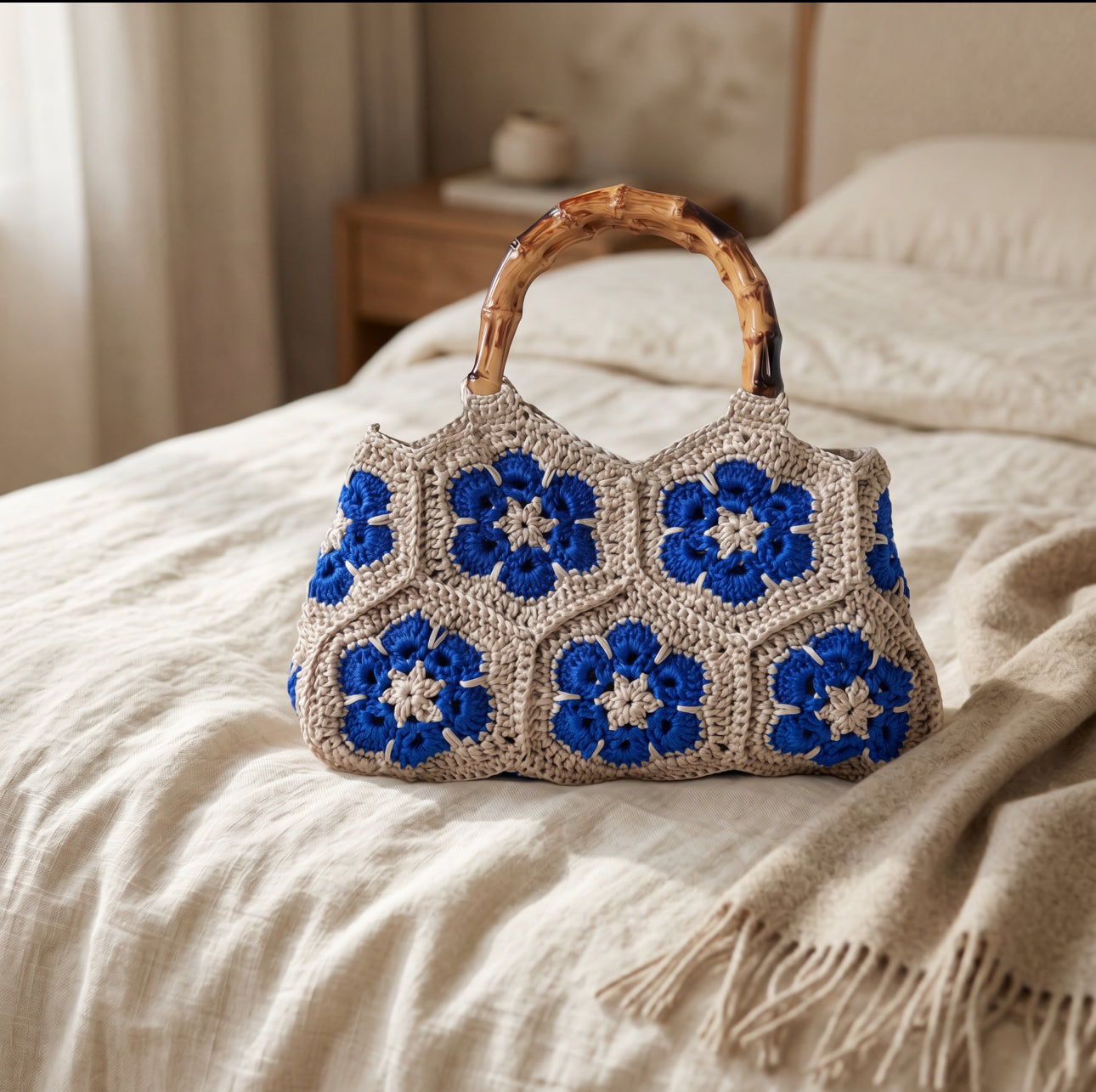 HopeKnot crochet tote in cream with cobalt blue granny square pattern, lifestyle shot